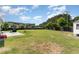 Lush green backyard featuring a basketball court, shed, and black fence at 123 Jonalker Ct, Clayton, NC 27520