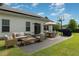 Inviting outdoor patio with solar panels, grill, dining, and seating area at 123 Jonalker Ct, Clayton, NC 27520