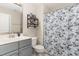 Neutral bathroom with stylish shower curtain, gray vanity, and lots of light at 123 Jonalker Ct, Clayton, NC 27520