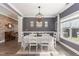 Elegant dining room with grey walls, modern light fixture and large window for natural light at 123 Jonalker Ct, Clayton, NC 27520