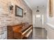 Inviting entryway with decorative brick wall, complemented by wood floors and a white front door at 123 Jonalker Ct, Clayton, NC 27520