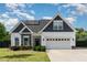 Charming two-story home featuring a mix of siding, stone accents, and a well-manicured lawn at 123 Jonalker Ct, Clayton, NC 27520