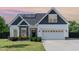 Charming two-story home featuring a mix of siding, stone accents, and a well-manicured lawn at 123 Jonalker Ct, Clayton, NC 27520