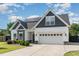 Charming two-story home featuring a mix of siding, stone accents, and a well-manicured lawn at 123 Jonalker Ct, Clayton, NC 27520