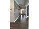 Inviting hallway with wood floors and a stylish brick accent wall adds character to the home at 123 Jonalker Ct, Clayton, NC 27520