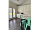 Bright kitchen featuring an island with seating, modern appliances, and access to the backyard at 123 Jonalker Ct, Clayton, NC 27520