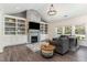 Open living room featuring built-in shelves, a fireplace, and a comfortable gray sofa at 123 Jonalker Ct, Clayton, NC 27520