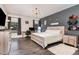 Modern bedroom with wood accent wall, plush carpet, and plenty of natural light at 123 Jonalker Ct, Clayton, NC 27520
