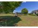Landscaped backyard offering a trampoline, mature trees, and well-maintained lawn at 130 Skipwith Dr, Wendell, NC 27591