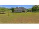 Expansive backyard with lush lawn, chain-link fence and mature trees offer privacy and outdoor enjoyment at 130 Skipwith Dr, Wendell, NC 27591