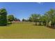A lush green backyard with mature trees and an enclosed fence at 130 Skipwith Dr, Wendell, NC 27591