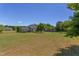 Expansive backyard featuring a lush green lawn, mature trees, and a beautifully landscaped area at 130 Skipwith Dr, Wendell, NC 27591
