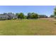 Extensive backyard featuring mature trees, play equipment, and a fenced perimeter, creating an ideal space for outdoor activities at 130 Skipwith Dr, Wendell, NC 27591