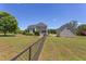 Spacious fenced backyard featuring a large home, detached garage, and plenty of green space for outdoor enjoyment at 130 Skipwith Dr, Wendell, NC 27591