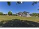 Spacious backyard with a well-maintained lawn, mature trees, and the home's exterior architecture at 130 Skipwith Dr, Wendell, NC 27591