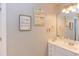 Bathroom vanity with a large mirror, a single sink, and modern lighting at 130 Skipwith Dr, Wendell, NC 27591