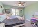 Cozy bedroom with pastel green walls, plush carpet, and a ceiling fan at 130 Skipwith Dr, Wendell, NC 27591