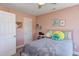 Bright bedroom with a ceiling fan, pink walls, and stylish decorations at 130 Skipwith Dr, Wendell, NC 27591