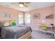 Pink bedroom featuring stylish decor, a ceiling fan, two windows, and a study desk at 130 Skipwith Dr, Wendell, NC 27591