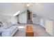 Spacious bonus room with a cozy couch, neutral decor, and ample space at 130 Skipwith Dr, Wendell, NC 27591