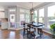 Dining area with a wood table set, lots of windows, and an overhead modern light fixture at 130 Skipwith Dr, Wendell, NC 27591