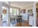 Dining area with a wood table and seating, art on the wall, and access to both the backyard and living room at 130 Skipwith Dr, Wendell, NC 27591