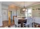Bright dining room featuring a wood table, white chairs, and an elegant light fixture at 130 Skipwith Dr, Wendell, NC 27591