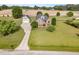 Stunning aerial view of a brick two-story home with a manicured lawn and detached garage at 130 Skipwith Dr, Wendell, NC 27591