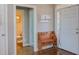 Warm foyer featuring a wood bench, hardwood floors and a glimpse of a nearby bathroom at 130 Skipwith Dr, Wendell, NC 27591