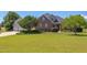 Charming brick home with a lush green lawn and mature trees creating lovely curb appeal at 130 Skipwith Dr, Wendell, NC 27591
