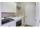 Functional laundry room with cabinets and plenty of storage space at 130 Skipwith Dr, Wendell, NC 27591
