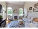 Bright living room with vaulted ceiling, fireplace, large windows, and comfortable furnishings at 130 Skipwith Dr, Wendell, NC 27591