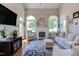 Inviting living room featuring a fireplace, large windows, and cozy seating at 130 Skipwith Dr, Wendell, NC 27591