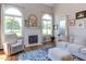 Comfortable living room with a fireplace, large windows, and neutral decor at 130 Skipwith Dr, Wendell, NC 27591