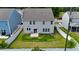 A well-maintained lawn and patio can be seen in this aerial view of the backyard at 1305 Addison Lake St, Fuquay Varina, NC 27526