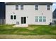 The backyard features a well-maintained lawn, sliding door, and a patio area, perfect for outdoor relaxation at 1305 Addison Lake St, Fuquay Varina, NC 27526