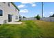 An open backyard boasts a freshly cut lawn, patio space, and secure white perimeter fencing at 1305 Addison Lake St, Fuquay Varina, NC 27526
