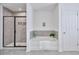 Modern bathroom featuring a tiled shower, soaking tub, and neutral color palette at 1305 Addison Lake St, Fuquay Varina, NC 27526