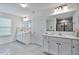 Bright primary bathroom with white cabinets, dual sinks, and large mirror at 1305 Addison Lake St, Fuquay Varina, NC 27526
