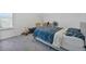 Cozy bedroom with a blue patterned bedspread and comfortable carpeting at 1305 Addison Lake St, Fuquay Varina, NC 27526