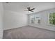 Bright and airy bedroom with neutral carpet and two large windows at 1305 Addison Lake St, Fuquay Varina, NC 27526