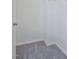 Empty walk-in closet with gray carpet and white walls, ready for personalized organization at 1305 Addison Lake St, Fuquay Varina, NC 27526