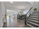 Open concept dining area with staircase, chandelier, and seamless transition to the modern kitchen at 1305 Addison Lake St, Fuquay Varina, NC 27526