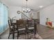 Elegant dining room with a wooden table and seating for six near the stairway at 1305 Addison Lake St, Fuquay Varina, NC 27526