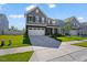 Beautiful two-story home with a two-car garage, stone accents, and a well-maintained lawn, inviting and appealing at 1305 Addison Lake St, Fuquay Varina, NC 27526