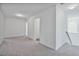 Hallway leading to bedrooms with gray carpet at 1305 Addison Lake St, Fuquay Varina, NC 27526