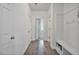 Inviting hallway with wood flooring and a built-in bench with hooks and storage at 1305 Addison Lake St, Fuquay Varina, NC 27526