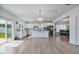 Open-concept kitchen with island, stainless appliances, and hardwood floors at 1305 Addison Lake St, Fuquay Varina, NC 27526