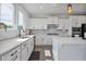 Well-lit kitchen with modern appliances, a stainless steel sink, and a view through the window at 1305 Addison Lake St, Fuquay Varina, NC 27526