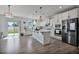 Bright kitchen featuring stainless steel appliances, a spacious island, and a sliding door to the backyard at 1305 Addison Lake St, Fuquay Varina, NC 27526